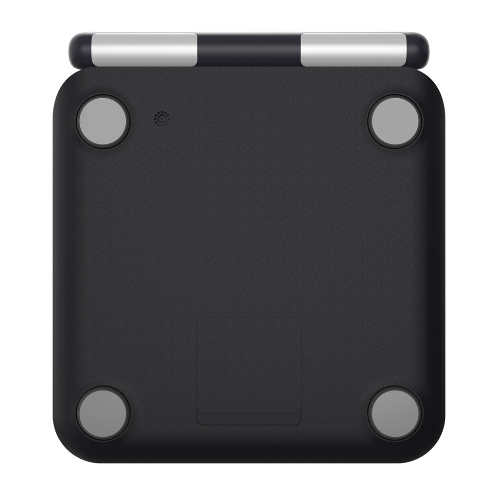 The bottom view of a digital scale showing its matte black textured body, four gray circular feet, and a silver and black hinge mechanism at the top, isolated on a white background.